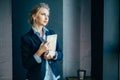 Skillful woman with beautiful blue eyes at workplace