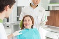 Skillful young orthodontist is working with a patient