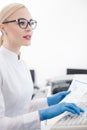 Skillful young researcher is working in lab Royalty Free Stock Photo
