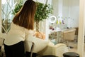 Skillful young woman standing near her client