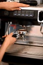 Skillfull barista making coffee in cafe or restaraunt using modern and professional coffee machine Royalty Free Stock Photo