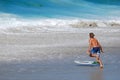 Skim Boarder prreparing to ride a shore break wave at Aliso Beach in Laguna Beach, California. Royalty Free Stock Photo