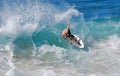 Skim Boarder riding a shore break wave at Aliso Beach in Laguna Beach, California. Royalty Free Stock Photo