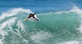 Skim Boarder riding a shore break wave at Aliso Beach in Laguna Beach, California. Royalty Free Stock Photo