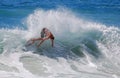 Skim Boarder riding a shore break wave at Aliso Beach in Laguna Beach, California.