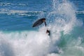 Skim Boarder wiping out while riding a shore break wave at Aliso Beach in Laguna Beach, California.