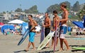 Skim Boarders wait for a wave to ride at Aliso Beach in Laguna Beach, California.