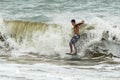 Skimboarder jumps on a wave