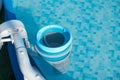 Skimmer on a round frame pool of a country house. Blue skimmer to clean pool in clear water. Side view from above. Royalty Free Stock Photo