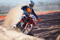 Skimming the edge. A motocross rider riding on the berm of the track.