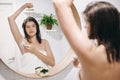 Skin and body care. Hair Removal concept. Woman after shower shaving with razor. Young attractive woman in white towel shaving Royalty Free Stock Photo