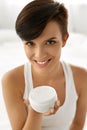 Skin Care. Beautiful Happy Woman Holding Face Cream, Lotion Royalty Free Stock Photo