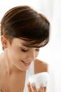 Skin Care. Beautiful Happy Woman Holding Face Cream Lotion Royalty Free Stock Photo