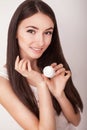 Skin Care. Beautiful healthy young woman with long hair, caring for their skin. Use cream for body care. Beauty and health Royalty Free Stock Photo