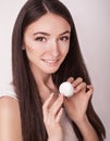 Skin Care. Beautiful healthy young woman with long hair, caring for their skin. Use cream for body care. Beauty and health Royalty Free Stock Photo