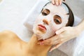 Skin and care. Beautiful Woman Lying With Face Mask. Pure and Beautiful Skin. Young Woman Makes a Face Mask. Caring for Salon. ?ig