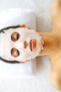 Skin and care. Beautiful Woman Lying With Face Mask. Pure and Beautiful Skin. Young Woman Makes a Face Mask. Caring for Salon. ?ig