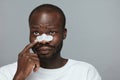 Skin Care. Beauty Treatment Concept. Man Applying White Nose Patch.
