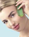 Skin care. Beauty Woman with perfect skin holding fresh leaf of Aloe Vera. Portrait of Beautiful Blonde Spa Girl with perfect skin Royalty Free Stock Photo