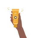 Skin care concept. African female hand holds tube of sunscreen. Facial cream with SPF. Protection for face from solar Royalty Free Stock Photo