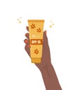 Skin care concept. African female hand holds tube of sunscreen. Facial cream with SPF. Protection for face from solar Royalty Free Stock Photo