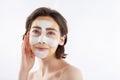 Dreamful pretty smiling woman with face mask