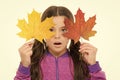 Skin care concept. Fall colors are funny. They are so bright and intense and beautiful. Kid girl hold fallen maple