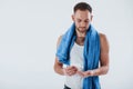 Skin care concept. Man with blue towel stands against white background in the studio Royalty Free Stock Photo