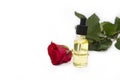 Skin care essence oil dropper glass bottle on white background. Skin care, red rose essential oil Royalty Free Stock Photo