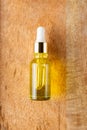 Skin care essence oil dropper glass bottle on wooden background. Hydrating serum, vitamin for face skin. Aesthetic Royalty Free Stock Photo