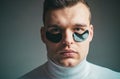 Skin care. Focused treatments for under eye area. Minimizes puffiness and reduce dark circles. Eye patches for men. Man Royalty Free Stock Photo