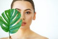 Skin Care. Green Leaf Shading a Half of Beautiful Woman Face. Be Royalty Free Stock Photo