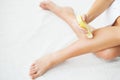 Skin Care and Health. Hair Removal. Fit Young Woman Waxing Her Legs With a Portable Roll-on Depilatory Wax Heater For Royalty Free Stock Photo