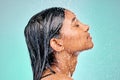 Skin care must be good enough to eat. an attractive young woman showering against a blue background. Royalty Free Stock Photo