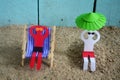 Skin care, paper men on the beach. Royalty Free Stock Photo