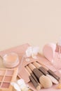 Skin care products and make up brushes on light beige close up, copy space Royalty Free Stock Photo