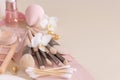 Skin care products and make up brushes on light beige close up, copy space Royalty Free Stock Photo