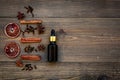 Skin care and relax. Cosmetics and aromatherapy concept. Cinnamon oil on dark wooden background top view copyspace