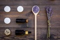 Skin care and relax. Cosmetics and aromatherapy concept. Lavender spa salt and oil on dark wooden background top view Royalty Free Stock Photo