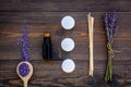 Skin care and relax. Cosmetics and aromatherapy concept. Lavender spa salt and oil on dark wooden background top view Royalty Free Stock Photo