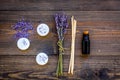 Skin care and relax. Cosmetics and aromatherapy concept. Lavender spa salt and oil on dark wooden background top view Royalty Free Stock Photo