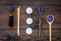 Skin care and relax. Cosmetics and aromatherapy concept. Lavender spa salt and oil on dark wooden background top view Royalty Free Stock Photo