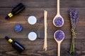 Skin care and relax. Cosmetics and aromatherapy concept. Lavender spa salt and oil on dark wooden background top view Royalty Free Stock Photo