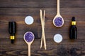 Skin care and relax. Cosmetics and aromatherapy concept. Lavender spa salt and oil on dark wooden background top view Royalty Free Stock Photo