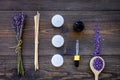 Skin care and relax. Cosmetics and aromatherapy concept. Lavender spa salt and oil on dark wooden background top view Royalty Free Stock Photo