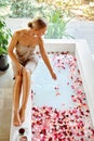 Skin Care Spa Treatment. Woman On Bathtub. Flower Rose Bath. Royalty Free Stock Photo