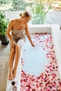 Skin Care Spa Treatment. Woman On Bathtub. Flower Rose Bath.