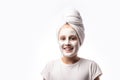 Skin care and spa treatments. Emotional portrait of a positive and cheerful beautiful teen girl with cosmetic mask on her faceon a Royalty Free Stock Photo