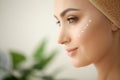 Skin care. Studio shot of beautiful young woman applying moisturizer cream onto her face Royalty Free Stock Photo