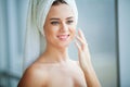 Skin care. Studio shot of beautiful young woman applying moisturizer cream onto her face Royalty Free Stock Photo